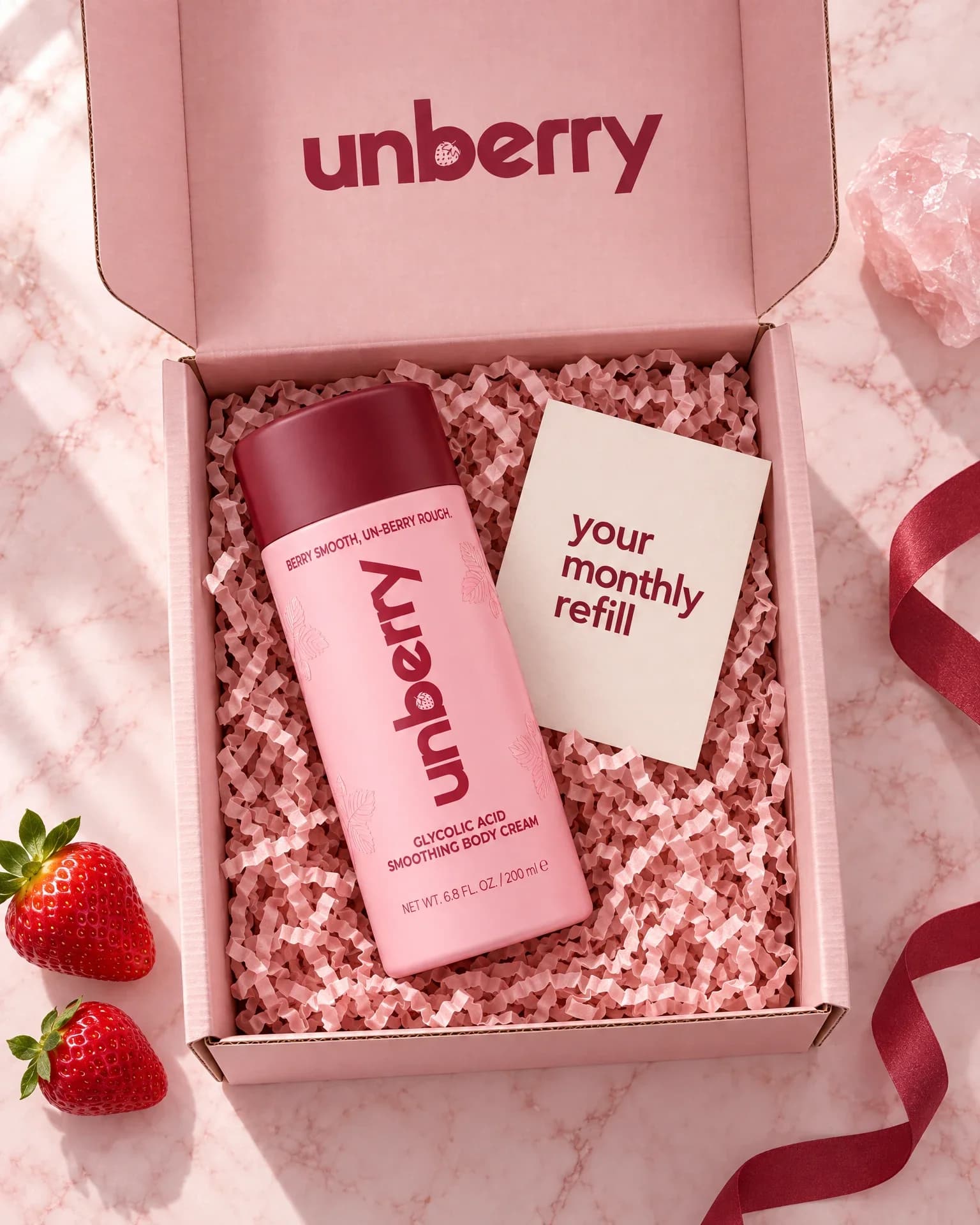An open unberry box with the body cream and a card reading: your monthly refill
